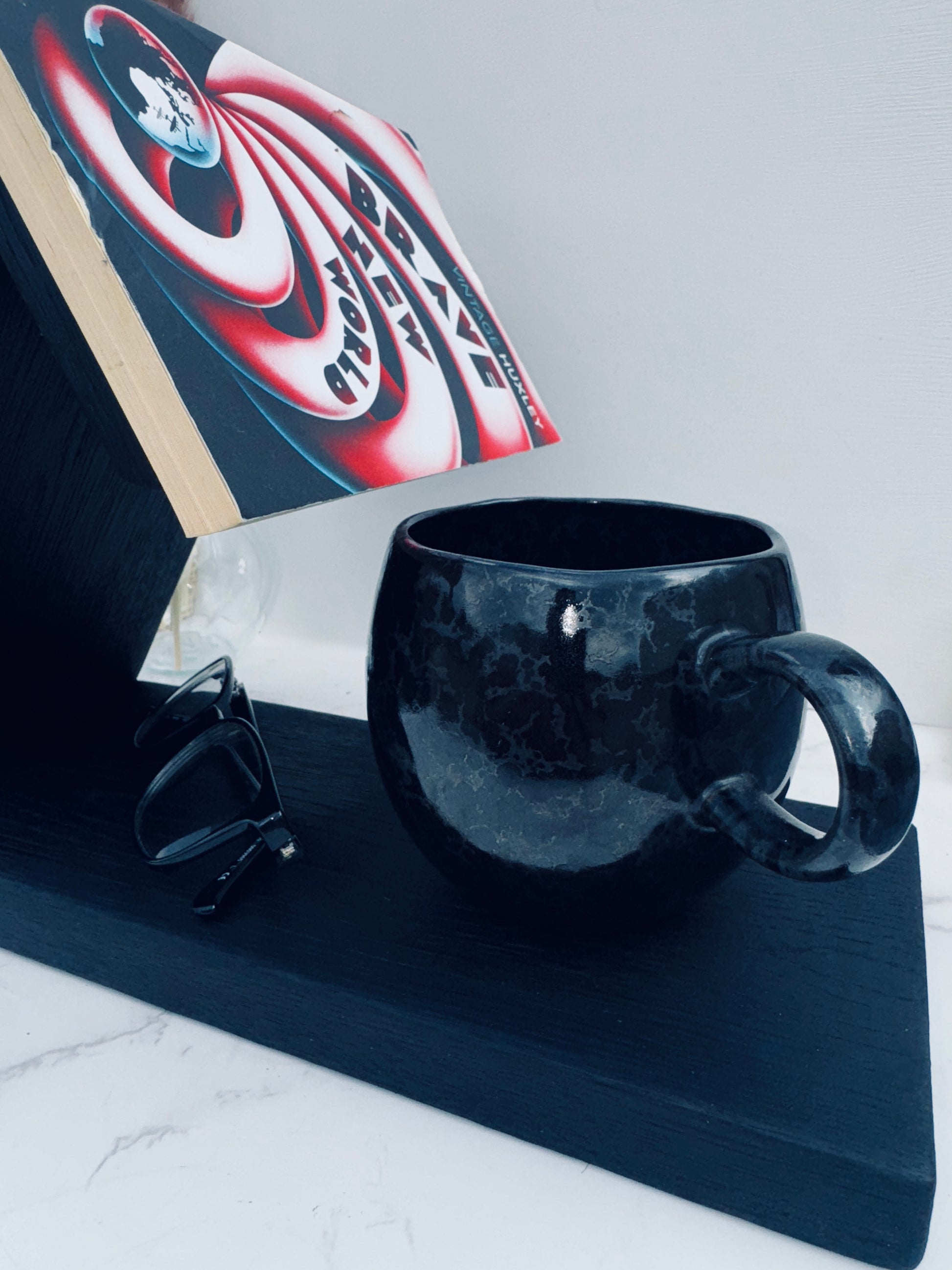 Book rest staged with a book glasses and mug from alternative angle 