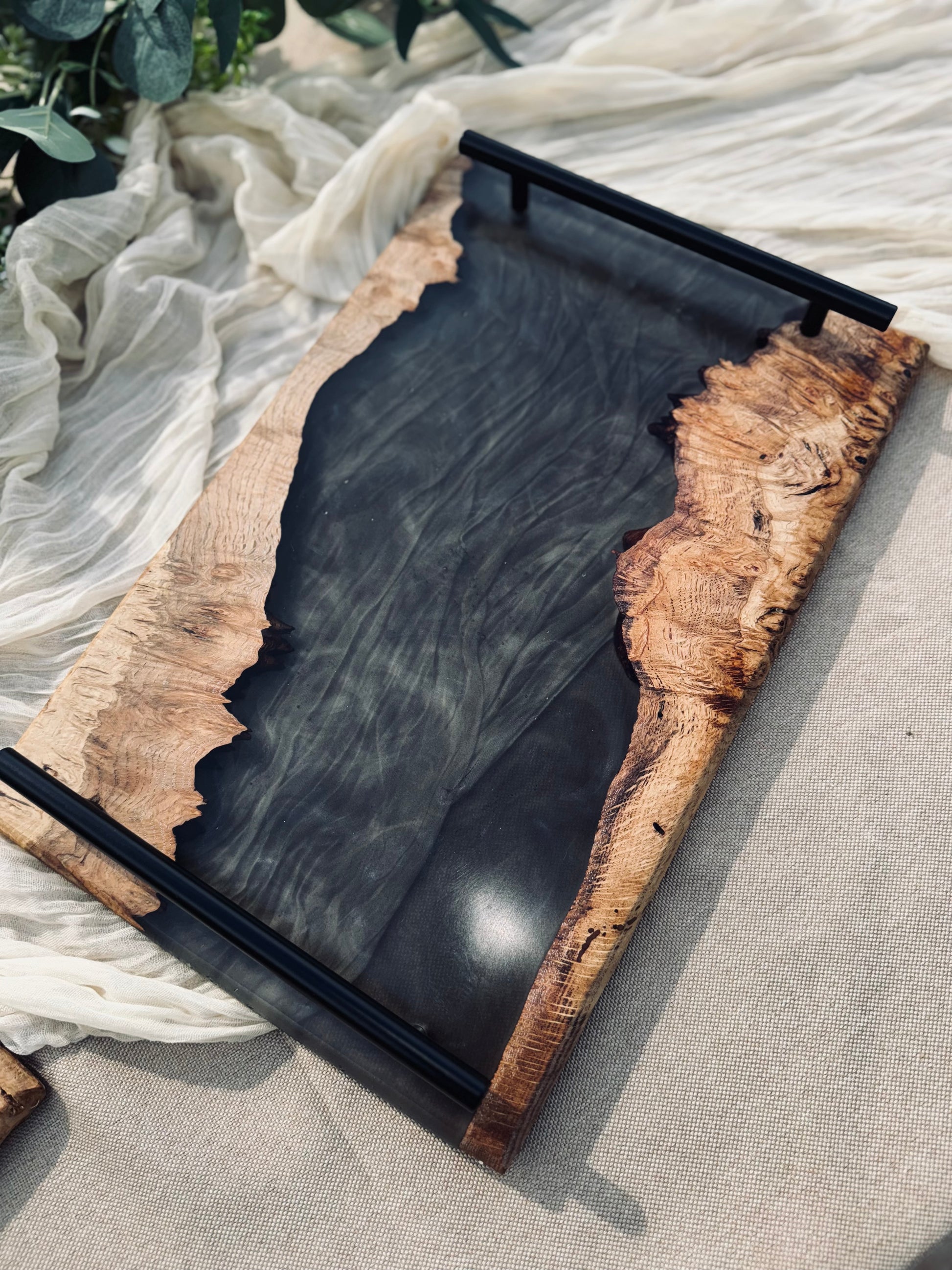 Oak and Smokey Epoxy Serving Tray on a beige table cloth and muslin. Full view.