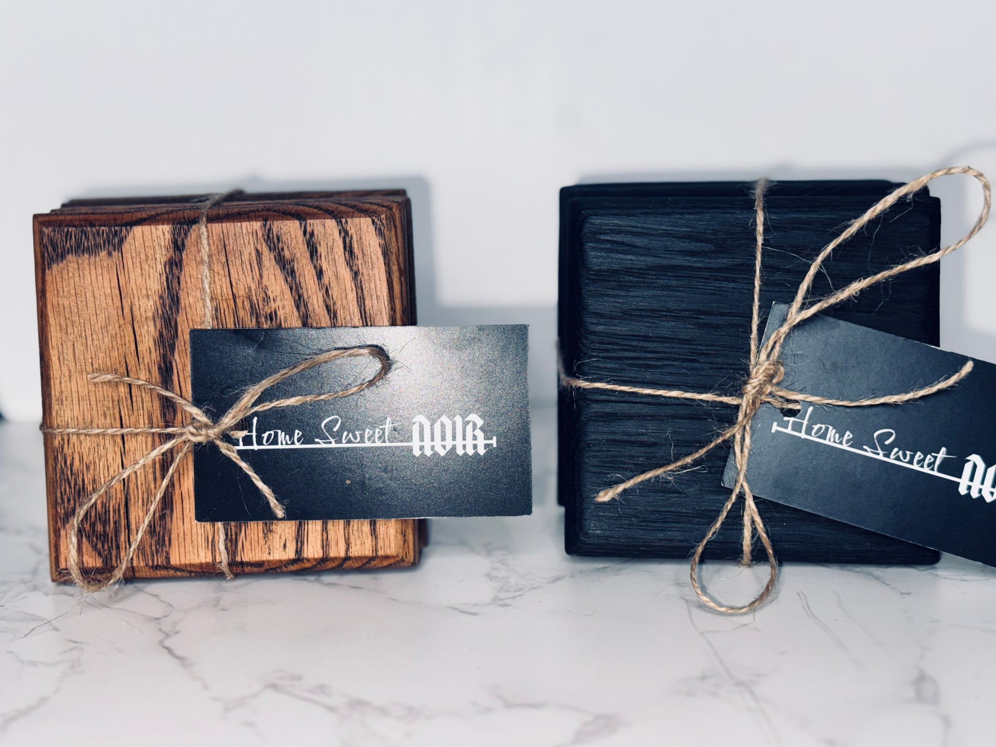 Bothe Shou Sugi Ban and charcoal finished coasters side by side wrapped in twine and displaying Home Sweet Noir tags