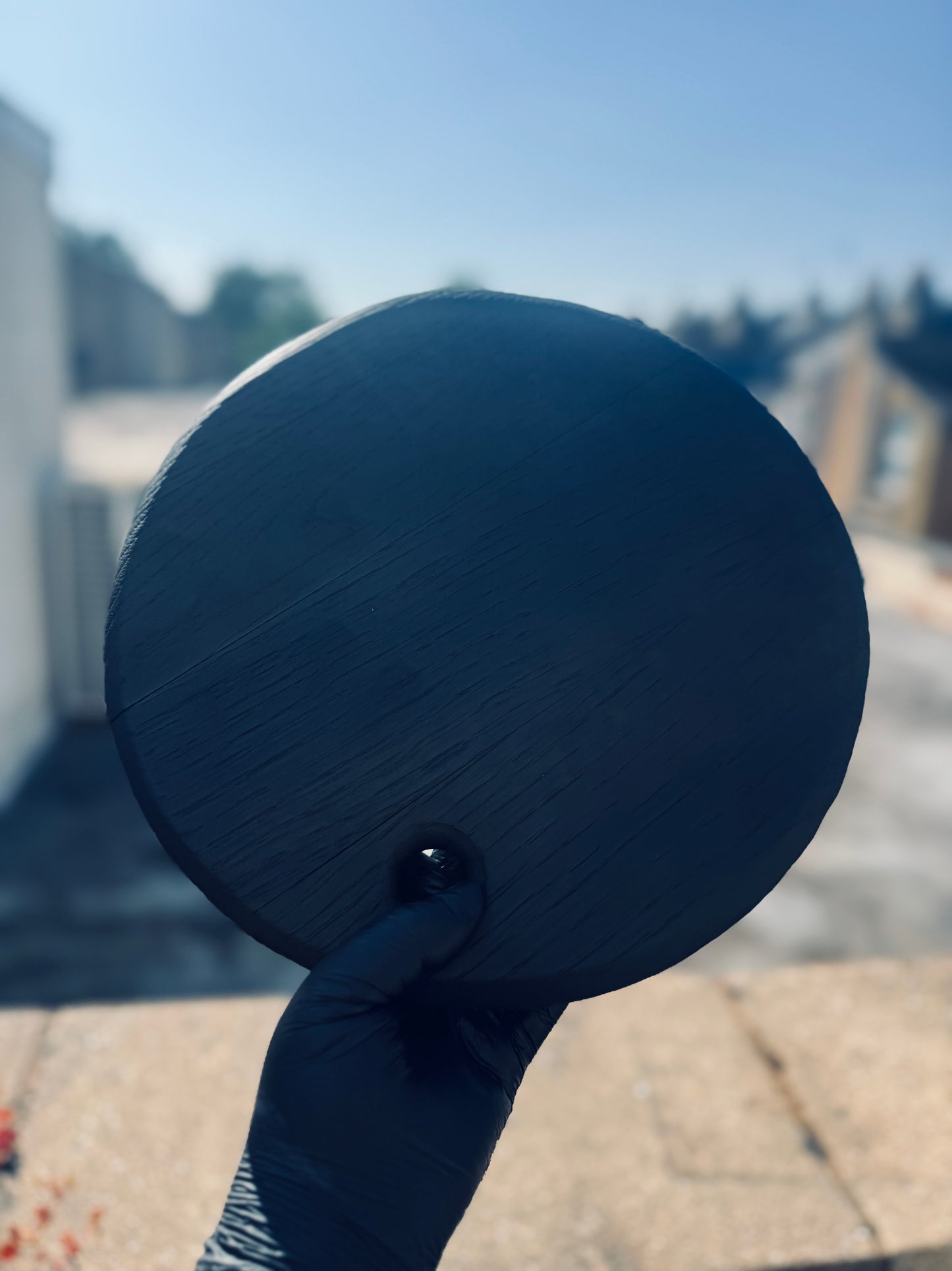 Image of the textured rim noir board being held up to the sunlight 